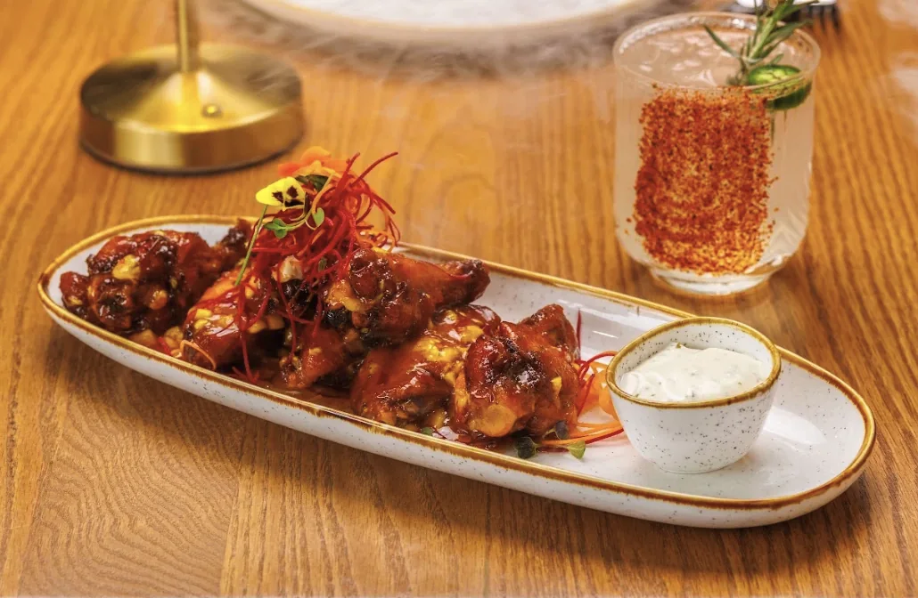 Glazed wings with ranch crema and a spicy paloma